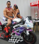 modèle femme homme fitness pose devant une moto de course à Angers 49